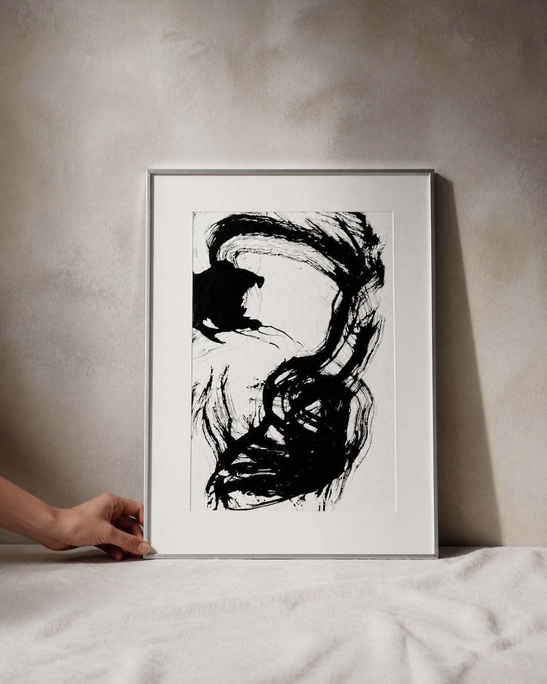 Hand holding a framed black-ink artwork by Vanshita Arora