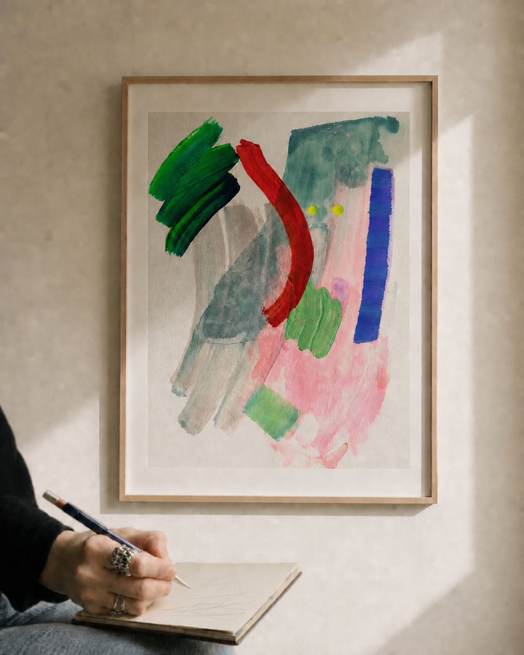 Studies 32 by Vanshita Arora displayed on a warm neutral wall beside an artist sketching.